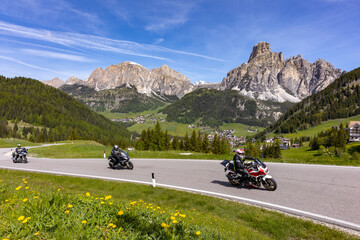 Motorcyclists ride into the Dolomites from Corvara, South Tyrol on a Sunny Day