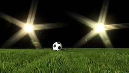 football rests on a pristine green pitch under the dramatic glare of a stadium floodlight at night.