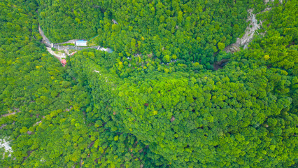 Aerial view of Skrad town and Zeleni Vir area in Gorski Kotar, Croatia. Scenic mountain landscape with green forest, winding roads, and scattered houses in lush nature