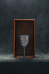 Still life with a cup in a wooden box