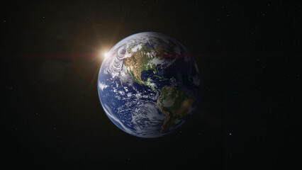 Fototapeta premium Earth globe showing sunrise shining over space continents and planet
