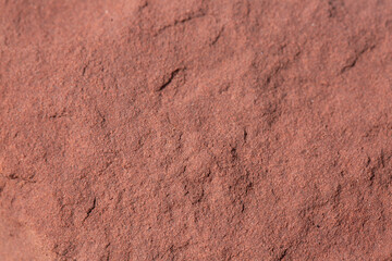 Macro reddish brown stone texture,Ancient Rock wall texture background. Rough Stone background texture. Reddish Stone wall.