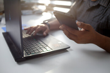 Man typing laptop and using smartphone for online shopping and paying by credit card, Online payment and shopping concept.