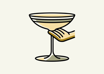 Hand holding a cocktail glass with yellow drink