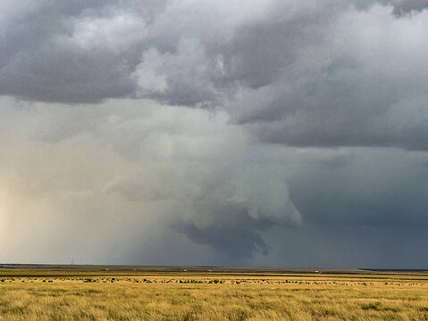 Tornado-warned storm lowers to the ground