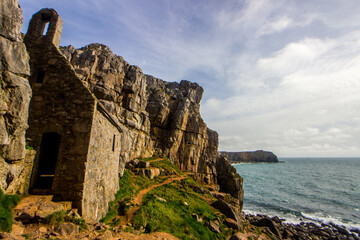 The small St Govans Chapel, hidden along the limestone cliffs of the Pembrokeshire coast of Wales. 
