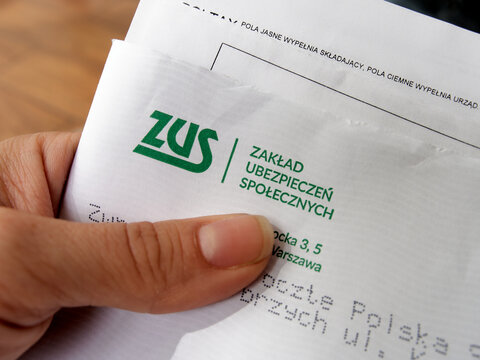 Hand holding a ZUS envelope, Polish social security document, official Polish document - 29.07.2025, Poland