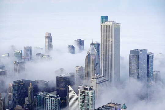 View from Willis Tower or Sears Building in Chicago with Fog Clouds Rolling in on the City Buildings