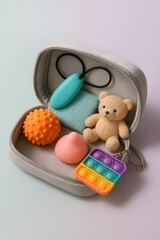 Flat Lay of Sensory Toy Kit for Kids with Autism or ADHD – Teddy Bear, Pop It and Fidget Tools in Case