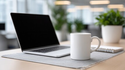 Modern office workspace with laptop, coffee mug, and indoor plants.