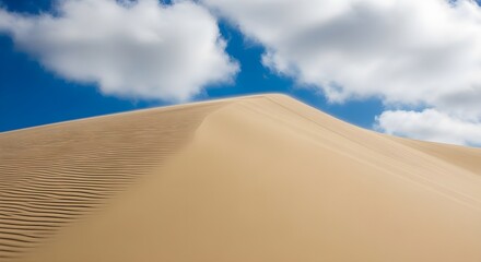 Windswept Sand Dune Crest Against a Vivid white and Blue Sky