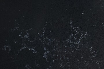 Texture of black marble surface as background, top view