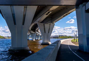 A concrete bridge with pillars across the bay in St. Petersburg.