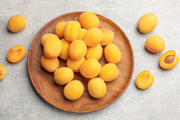 Fresh ripe apricots on grey table, flat lay