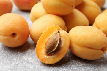 Fresh ripe apricots on grey table, closeup