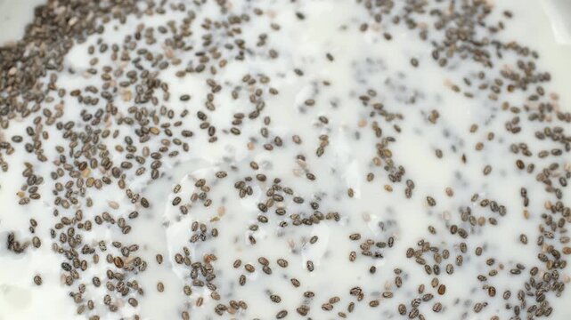 Chia seeds with cream yogurt top view, rotate. Cooking Chia pudding healthy snack