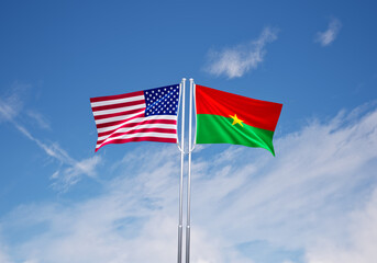 flags of  burkina faso and United States of America over blue sky background.