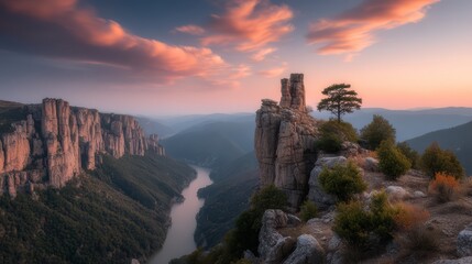Fototapeta premium Beautiful mountain range with a river running through it. The sky is a mix of pink and orange hues, creating a serene