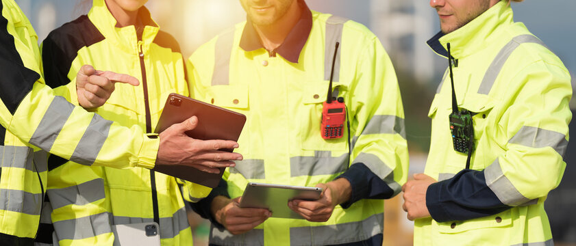 Engineer workers, Teamwork of engineers. Team of engineer standing together discussing and planning for working with digital tablet. Cooperation of workers. Unity and teamwork concept