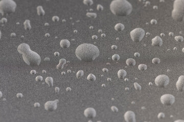 smooth silver-colored metal surface covered with drops of pure water, wet silver-colored metal painted to protect aluminum alloy and metals