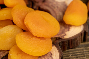 dried apricots are dehydrated after removing the seeds, apricots on a wooden board