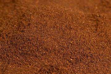 background of ground coffee beans for making a high-quality and aromatic coffee drink, closeup