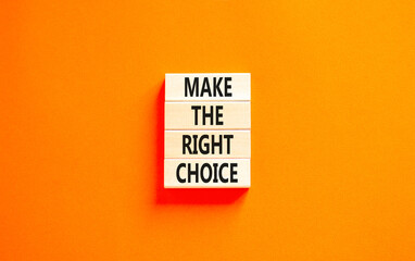 Make the right choice symbol. Concept words phrase Make the right choice on beautiful wooden blocks. Beautiful orange paper background. Business Make the right choice concept. Copy space.