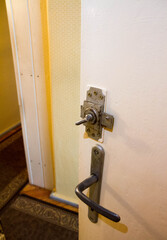 Old style latch and handle on a bathroom door