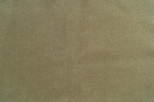 Beige cotton fabric.A photo of the texture of a green protective fabric.