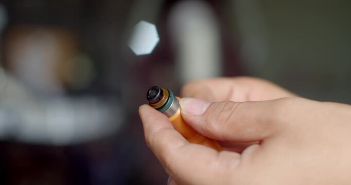 Applying grease to the fuel injector O-ring to ensure smooth insertion and prevent damage during installation.
