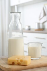Dairy products. Fresh milk and cheese on wooden table in kitchen