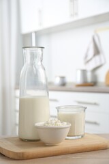 Dairy products. Fresh milk and cottage cheese on wooden table in kitchen