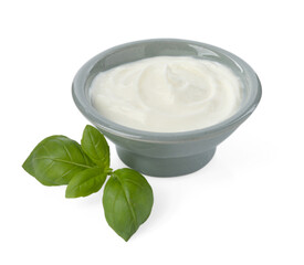 Tasty yoghurt in bowl and basil isolated on white