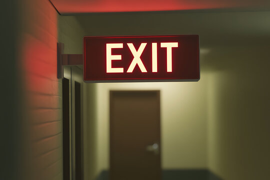 Illuminated Exit Sign: A stark red exit sign glows in a dimly lit hallway, offering guidance towards safety and a way out during emergencies.