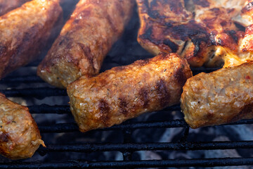 Pork chops, steak, sausages on barbecue grill