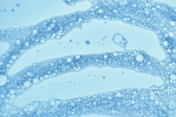 Shampoo bubbles on a blue background.