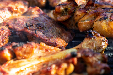 Pork chops, steak, sausages on barbecue grill