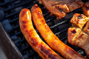 Pork chops, steak, sausages on barbecue grill