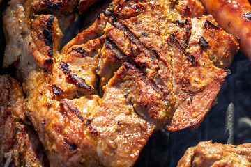 Pork chops, steak, sausages on barbecue grill