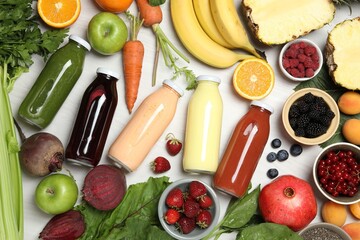 Superfood. Bottles with healthy drinks and ingredients on light wooden table, flat lay