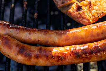 Pork chops, steak, sausages on barbecue grill