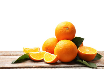 Pile of juicy oranges and green leaves on wooden table against white background