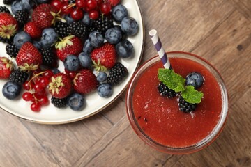 Superfood. Tasty smoothie in glass and ingredients on wooden table, flat lay