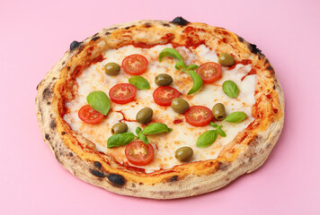 Delicious pizza with tomatoes, olives and basil on pink table, closeup