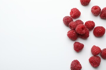 Tasty fresh ripe raspberries on white background, flat lay. Space for text