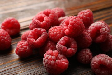 Tasty fresh ripe raspberries on wooden table, closeup