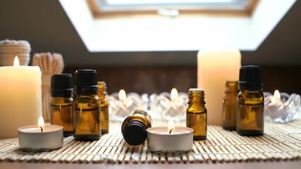 Relaxing aromatherapy session with essential oils and flickering candles creates a calming spa atmosphere for wellness and self-care routines