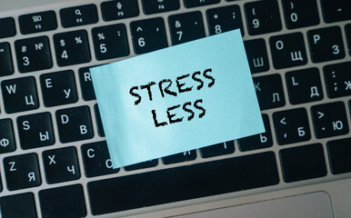 A stress less sticker on a laptop keyboard, a reminder for well-being.