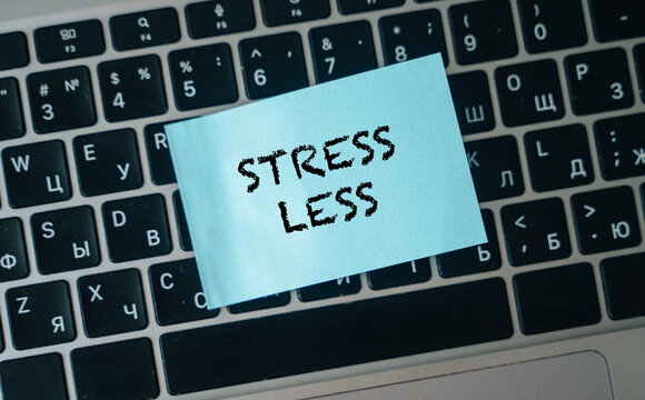A stress less sticker on a laptop keyboard, a reminder for well-being.