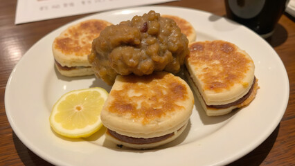 Stack of Japanese Dorayaki Pancakes with a Lemon slice on the plate